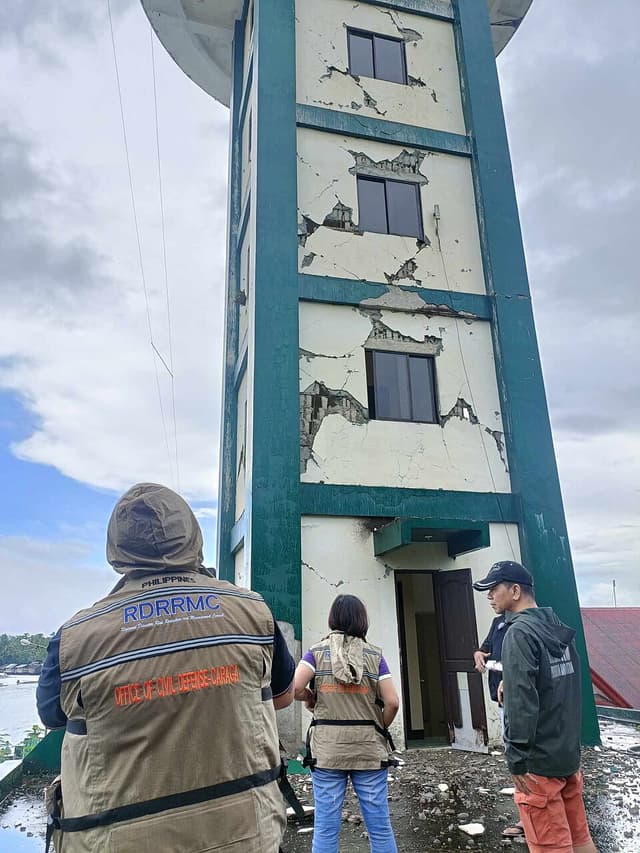 Office of Civil Defense Caraga personnel inspect the cracked walls of the PAGASA Doppler radar station in Hinatuan, Surigao del Sur, a day after the December 2, 2023 earthquake
